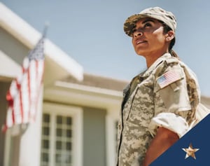 military service member stands in front of a US flag