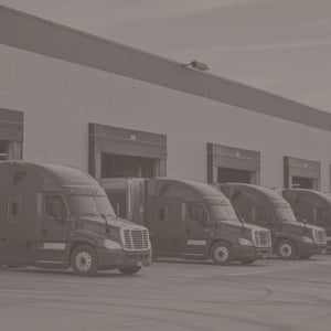 semi trucks parked outside a loading station