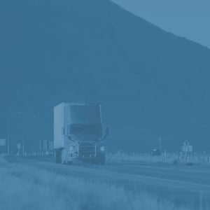 head-on shot of a semi truck driving along a highway
