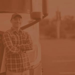 Male truck driver poses in front of his semi truck