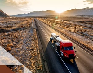 Truck drives along a desert road