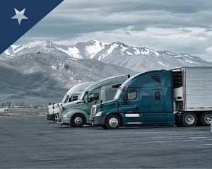 row of trucks parked at a truck stop