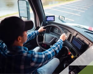 owner operator drives his truck safely through a parking lot