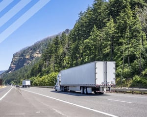 white semi truck driving along a forrest road