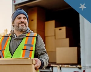 Truck driver smiles as he unloads his truck