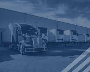 Semi trucks parked at a loading bay
