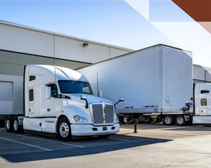may white trucks parked at a loading bay
