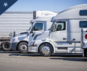 Commercial trucks parked at a truck stop