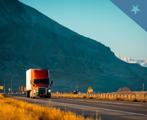 Semi truck drives along a road
