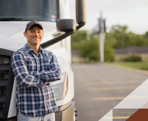 Male operator stands in front of his commercial truck