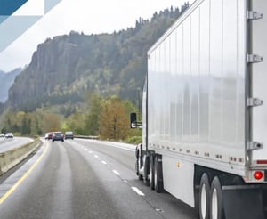 commercial truck drives through a scenic mountain route