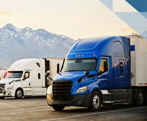 blue and white semi trucks parked at a truck stop