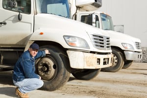 Truck-driver-inspecting-tires -3